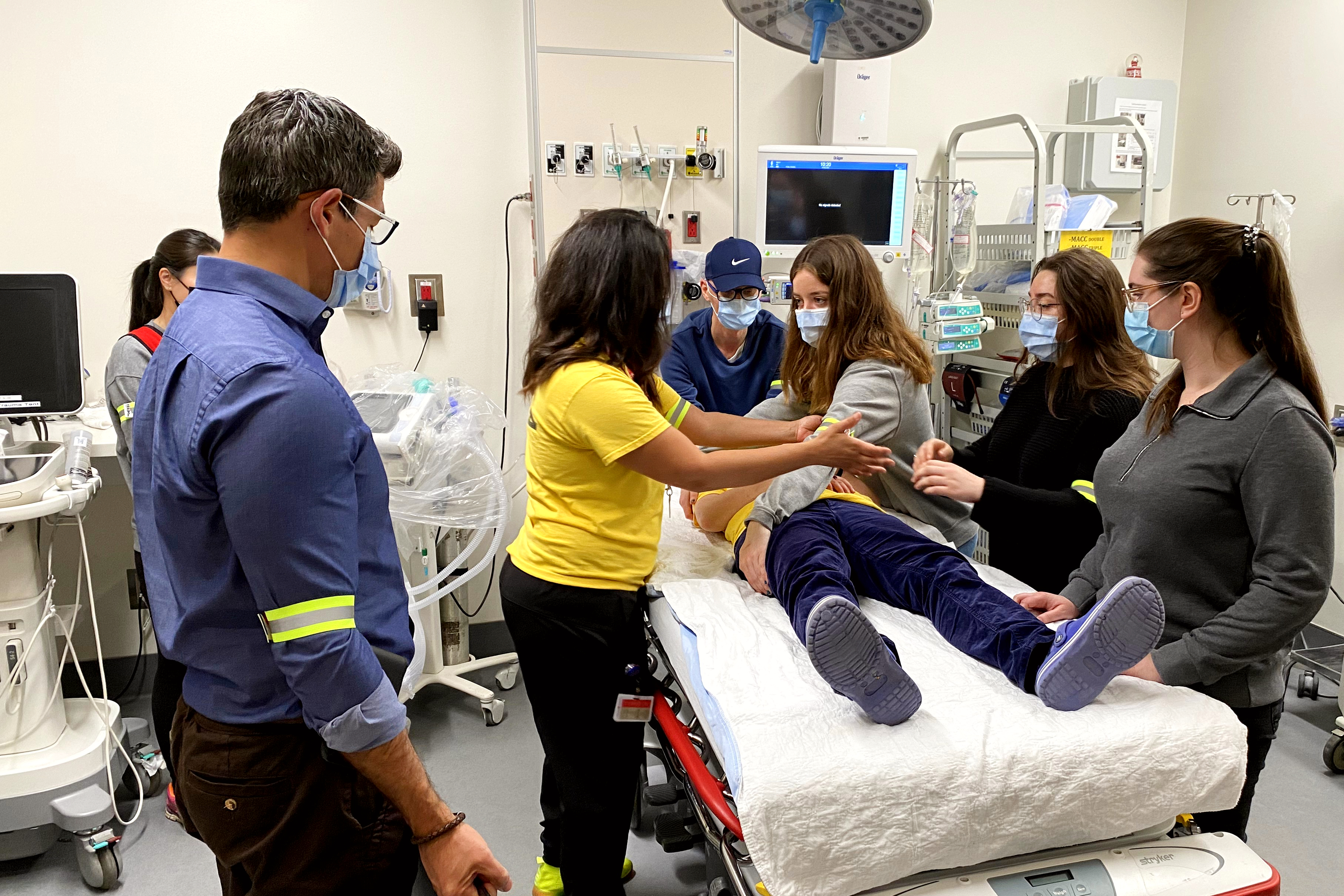 group rallies around the patient bed