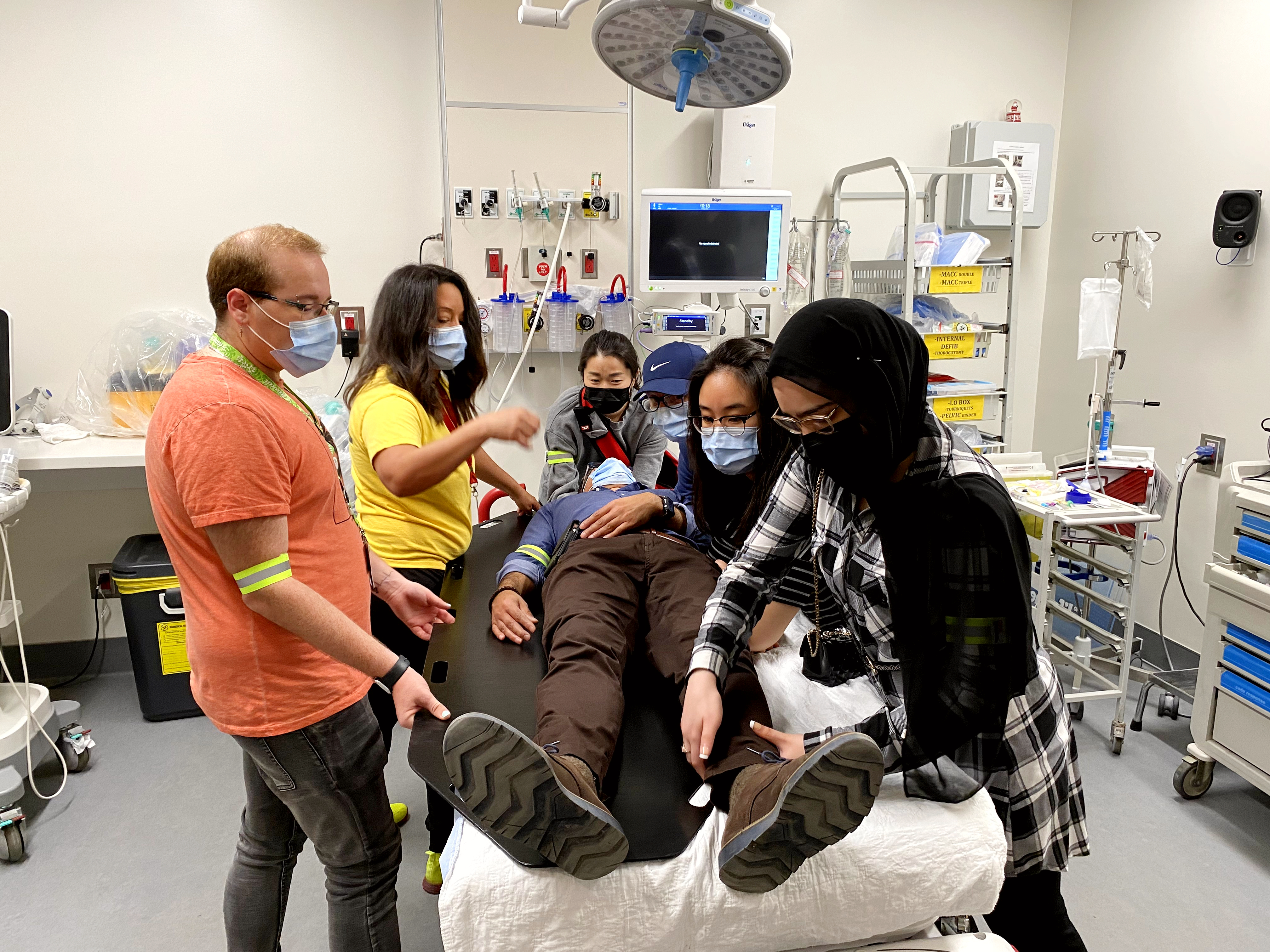 group rallies around the patient bed