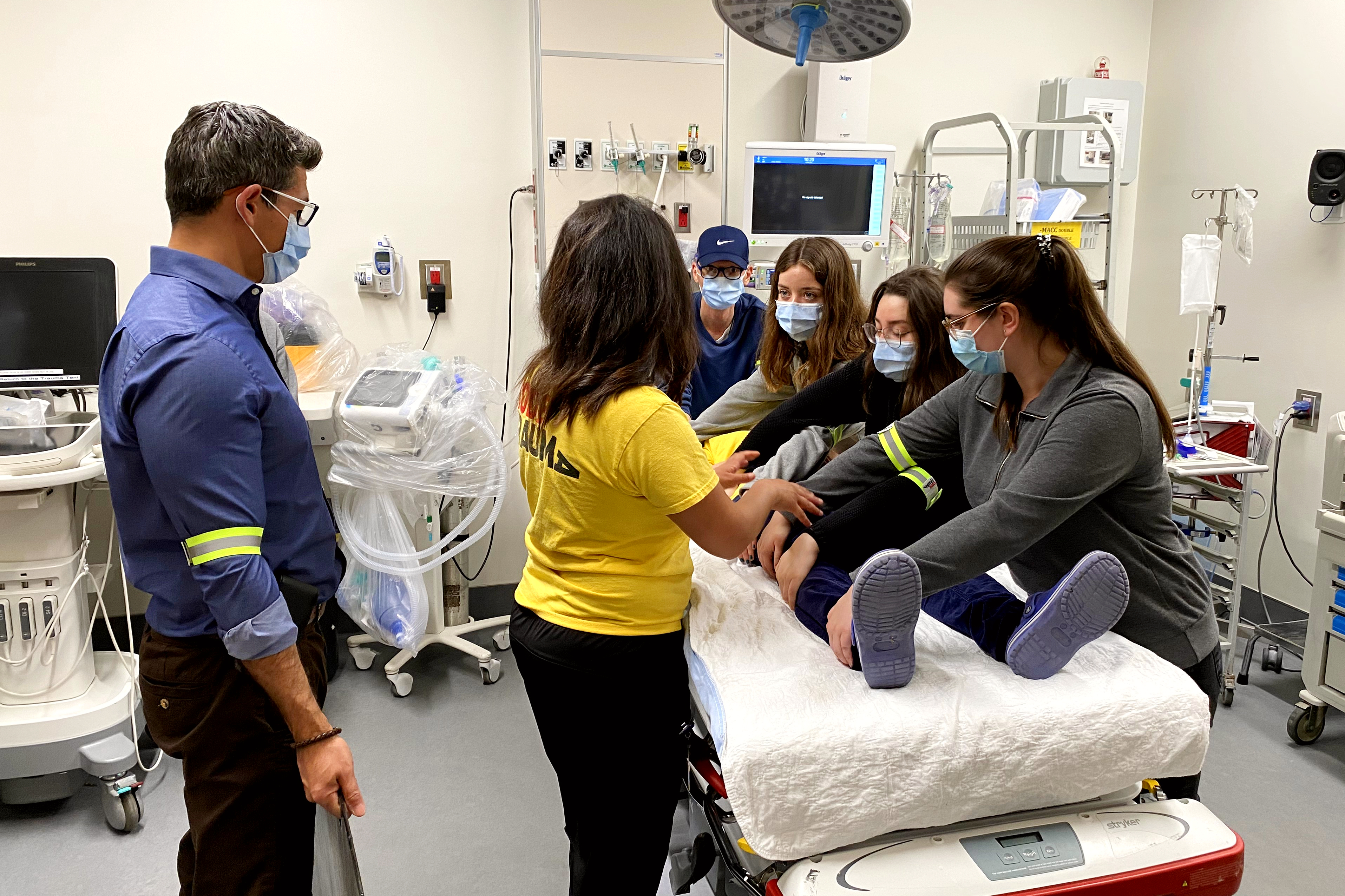 group rallies around the patient bed