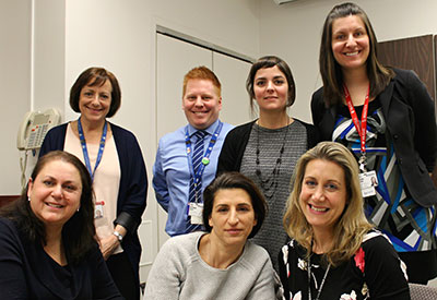 Staff members and patients collaborated as equals to improve the MS Clinic’s phone service. From left to right, front row: patient representatives Mari-Jo Pires and Emmanuelle Simony; Lucy Wardell, nursing practice manager. Back row: Diane Lowden, clinical nurse specialist; Noé Djawn White, Continuous Improvement advisor acting as QI facilitator; Karine Vigneault, Patient Partnership coordinator; Isabelle Parent, Clerical staff supervisor. Not in the picture: Dr. Paul Giacomini, neurologist; Katia Prévost, patient representative.