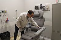 Denis prepares the examination room for the arrival of patients.