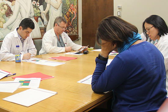 Patient partner Lia (in blue) is part of the perioperative care and invasive procedures team working on the QMENTUM process at the Neuro. From left to right: Dr. Roberto Diaz, neurosurgeon, Martin Tremblay, assistant nurse manager, Dorothée Hum, nurse practitioner.