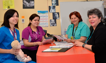 Front-line nurses Alexandra Lavoie-Richer, holding the doll, and Diane Viveiros, receive coaching from Anna Balenzano and Linda Boisvert on how to educate new parents about Shaken Baby Syndrome