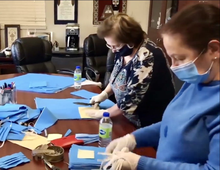 Members of the Armenian community sewing masks out of the wrappers' fabric