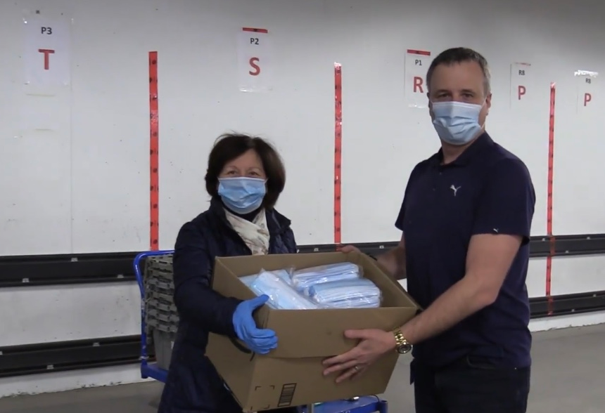 Steeve Gaudreault, specialty products consultant for the operating rooms (OR) at the McGill University Health Centre (MUHC), accepting masks from Ms. Ani Ohanian from ARS-Canada (Armenian Relief Society).