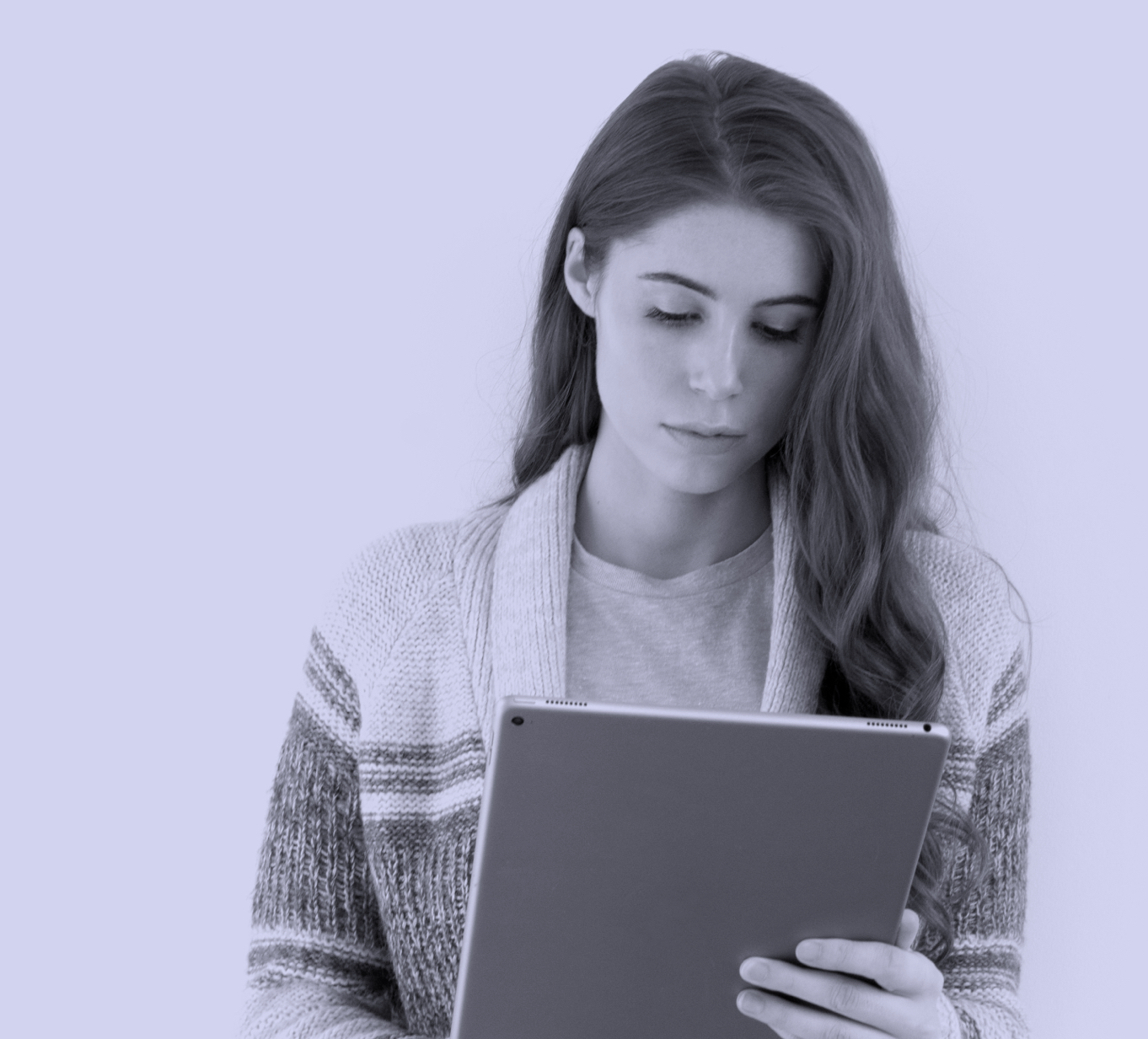 Young woman reading on a tablet.