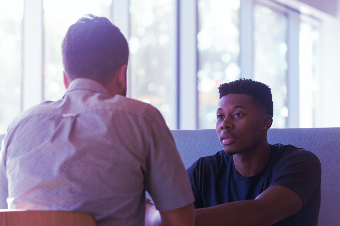 Two young men discussing