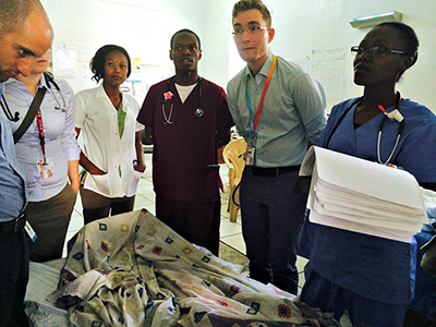 Dr. Battat (left) and Dr. Filewod (centre-right) participating in bedside rounds during their one-month stay in St. Marc, Haiti.